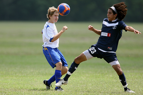 two young athletes playing soccer