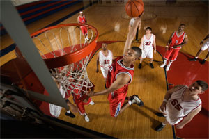 group of collegiate athletes playing basketball
