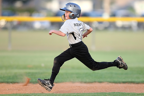 kid playing baseball running the bases