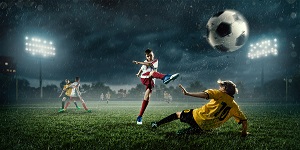 kids playing soccer in the rain
