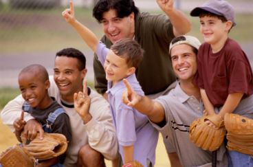 Kids and adults playing baseball